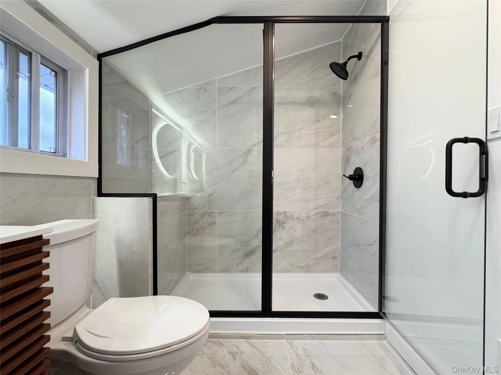 Bathroom with a shower stall and vanity Bathroom with a shower stall and vanity