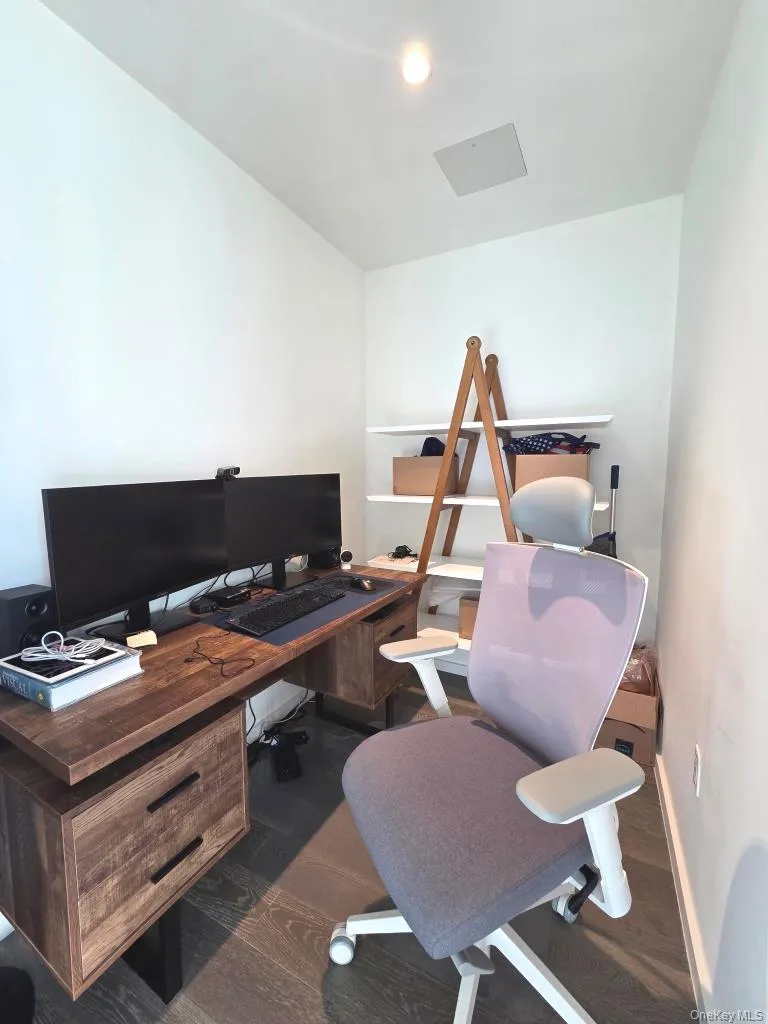 Home office featuring baseboards and dark wood finished floors Home office featuring baseboards and dark wood finished floors