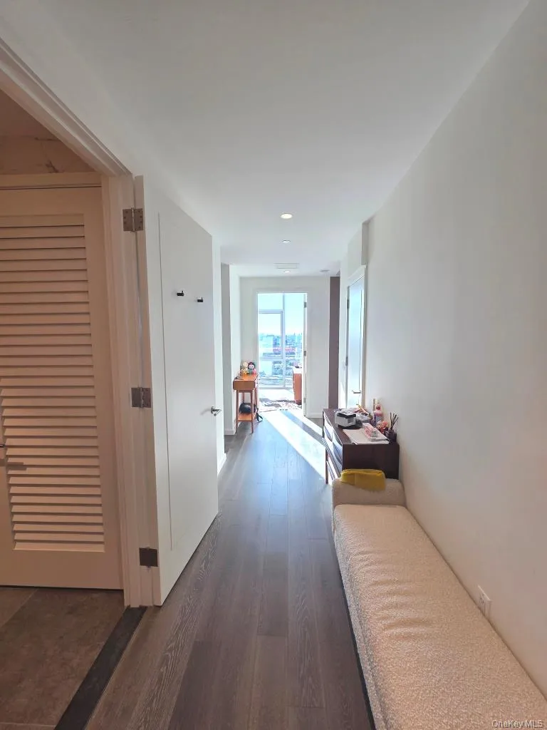 Hallway with dark wood-style flooring and recessed lighting Hallway with dark wood-style flooring and recessed lighting