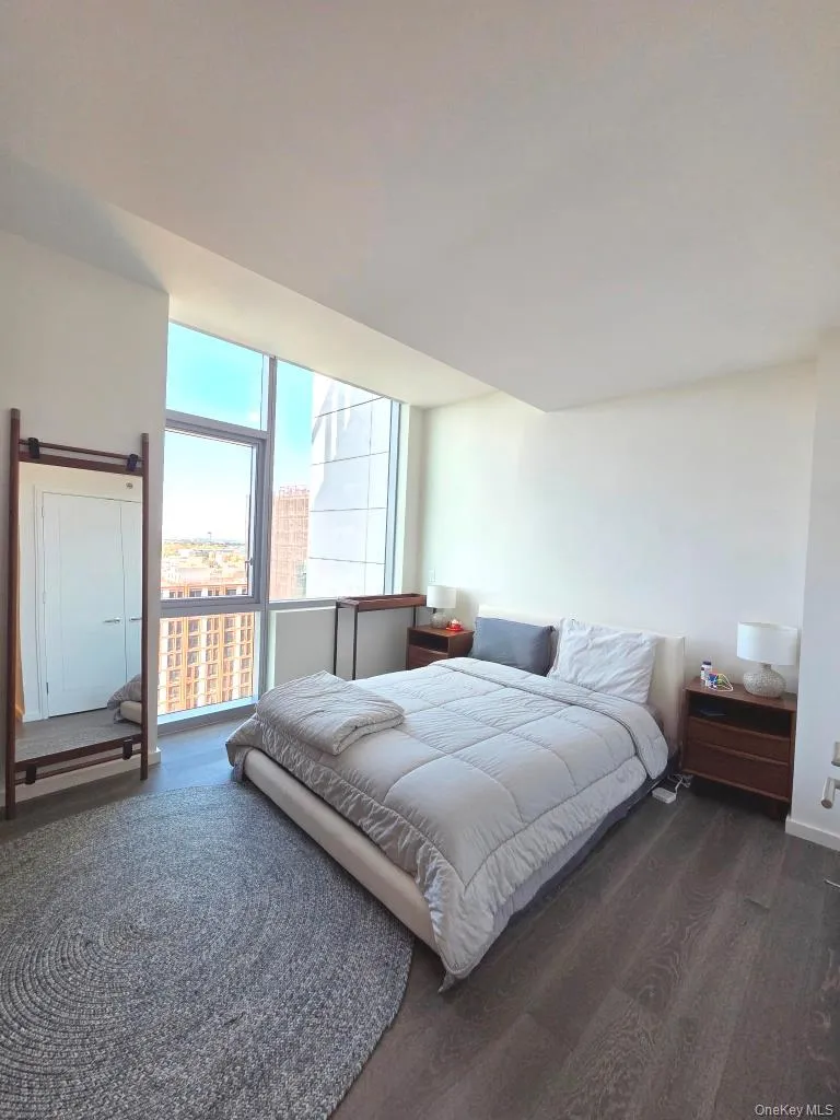 Bedroom with dark wood finished floors Bedroom with dark wood finished floors