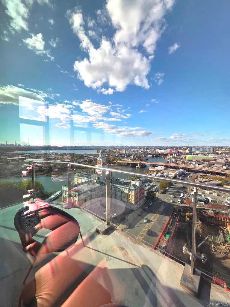 Balcony with a view of city and a water view Balcony with a view of city and a water view