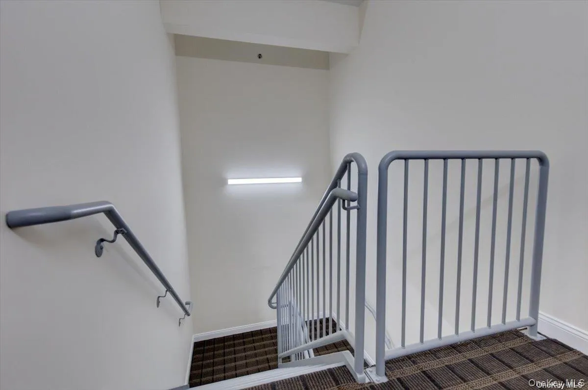 Stairs with baseboards and carpet flooring Stairs with baseboards and carpet flooring