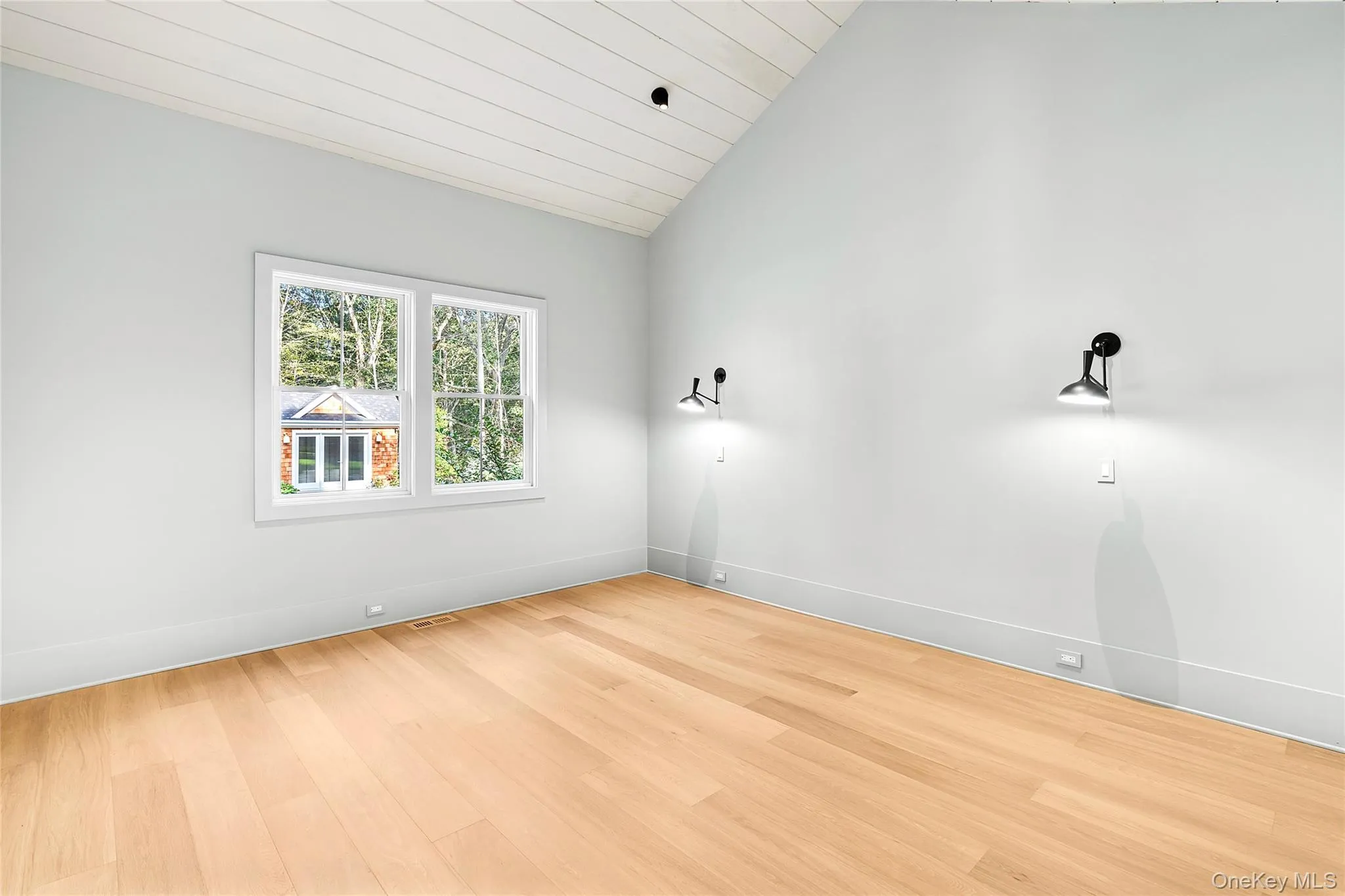 First floor primary bedroom with vaulted ceiling, light wood-type flooring, and wood ceiling. Includes walk-in closet, and primary bathroom First floor primary bedroom with vaulted ceiling, light wood-type flooring, and wood ceiling. Includes walk-in closet, and primary bathroom