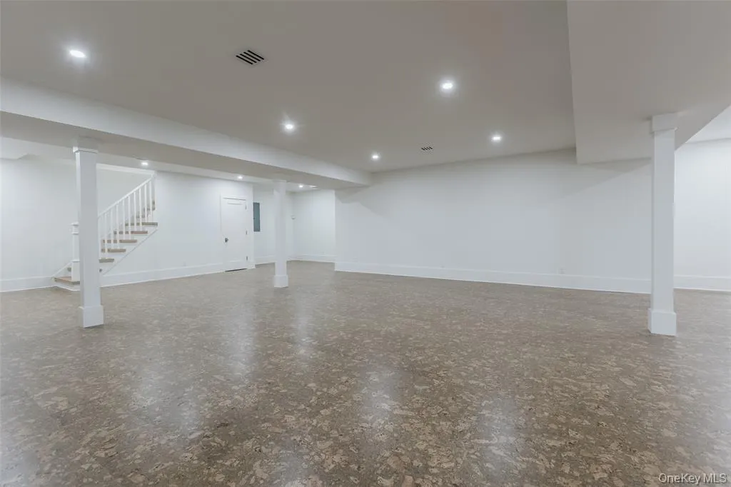 Finished basement with stairs and recessed lighting Finished basement with stairs and recessed lighting