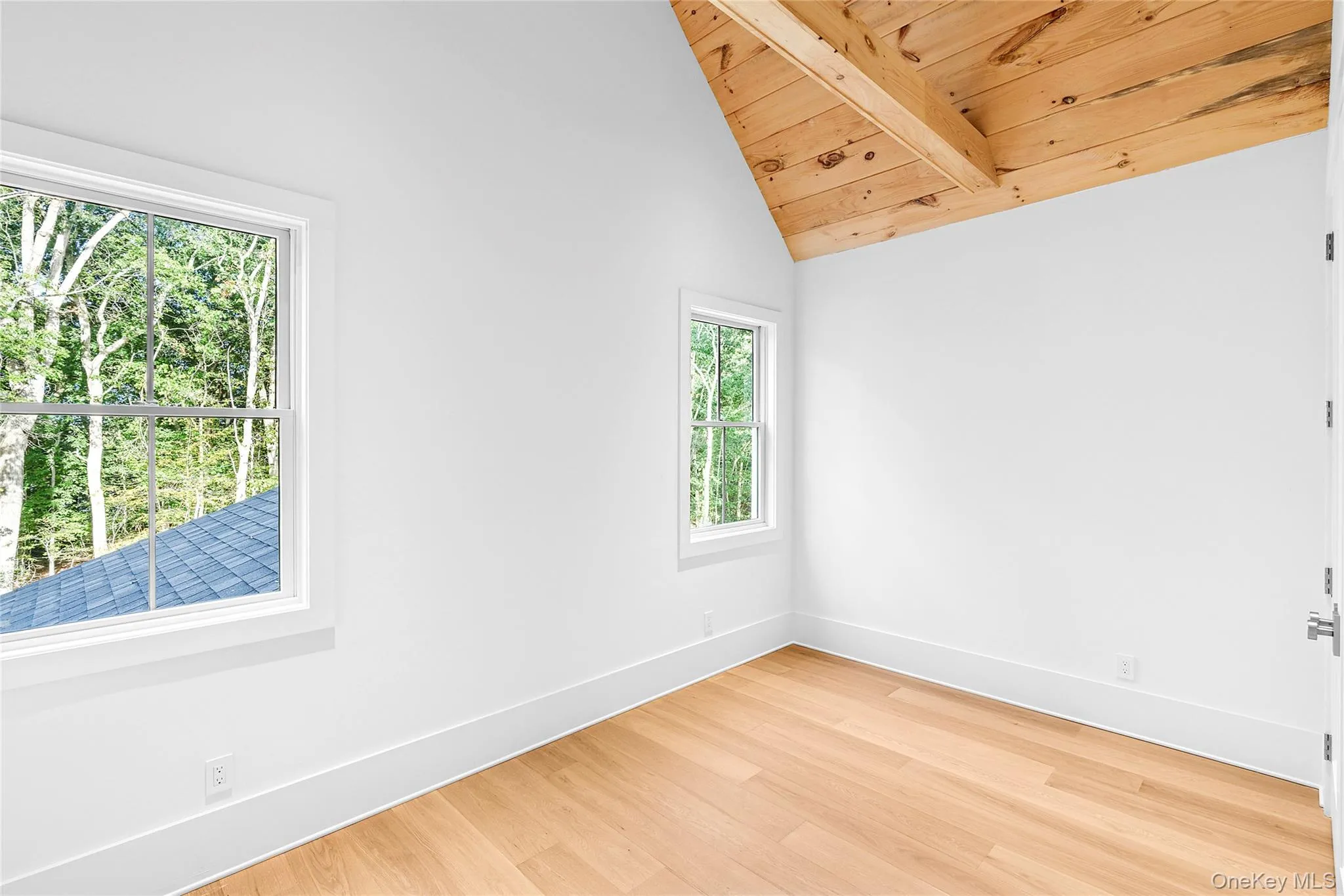 Bedroom with light wood-style floors and wooden ceiling Bedroom with light wood-style floors and wooden ceiling