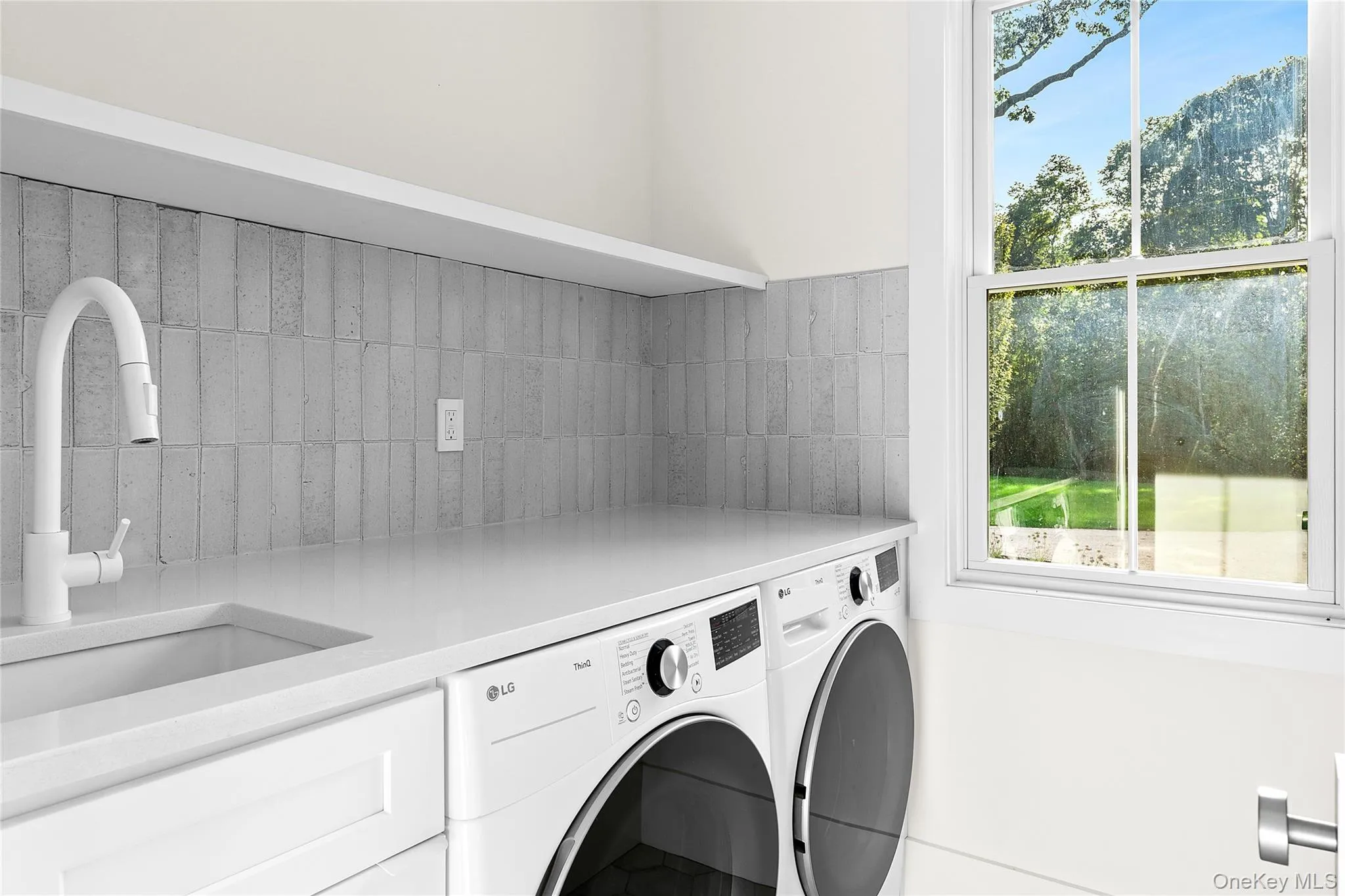 Laundry room featuring healthy amount of natural light and independent washer and dryer Laundry room featuring healthy amount of natural light and independent washer and dryer