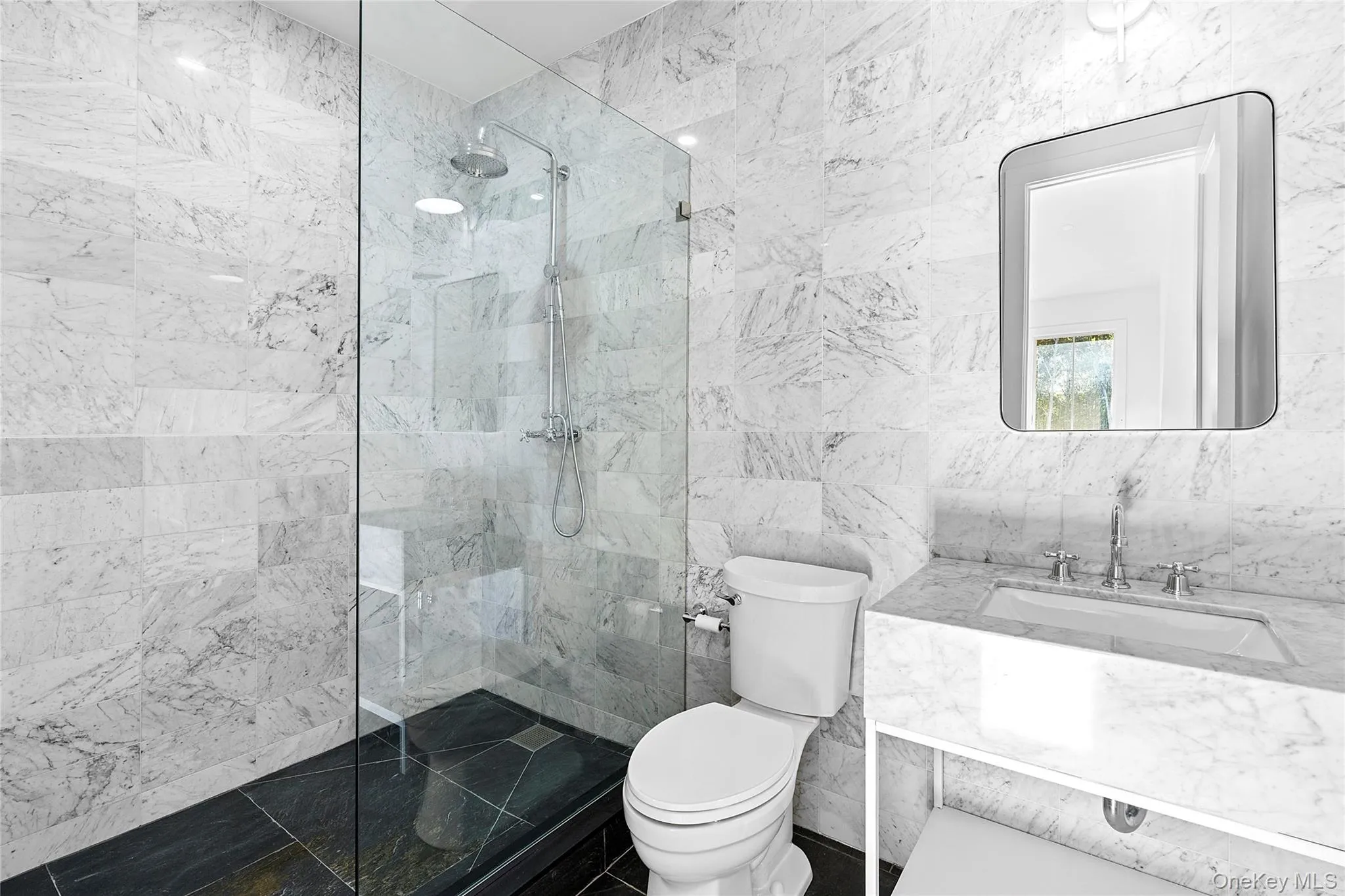 Full bath featuring tile walls, a walk in shower, and vanity Full bath featuring tile walls, a walk in shower, and vanity
