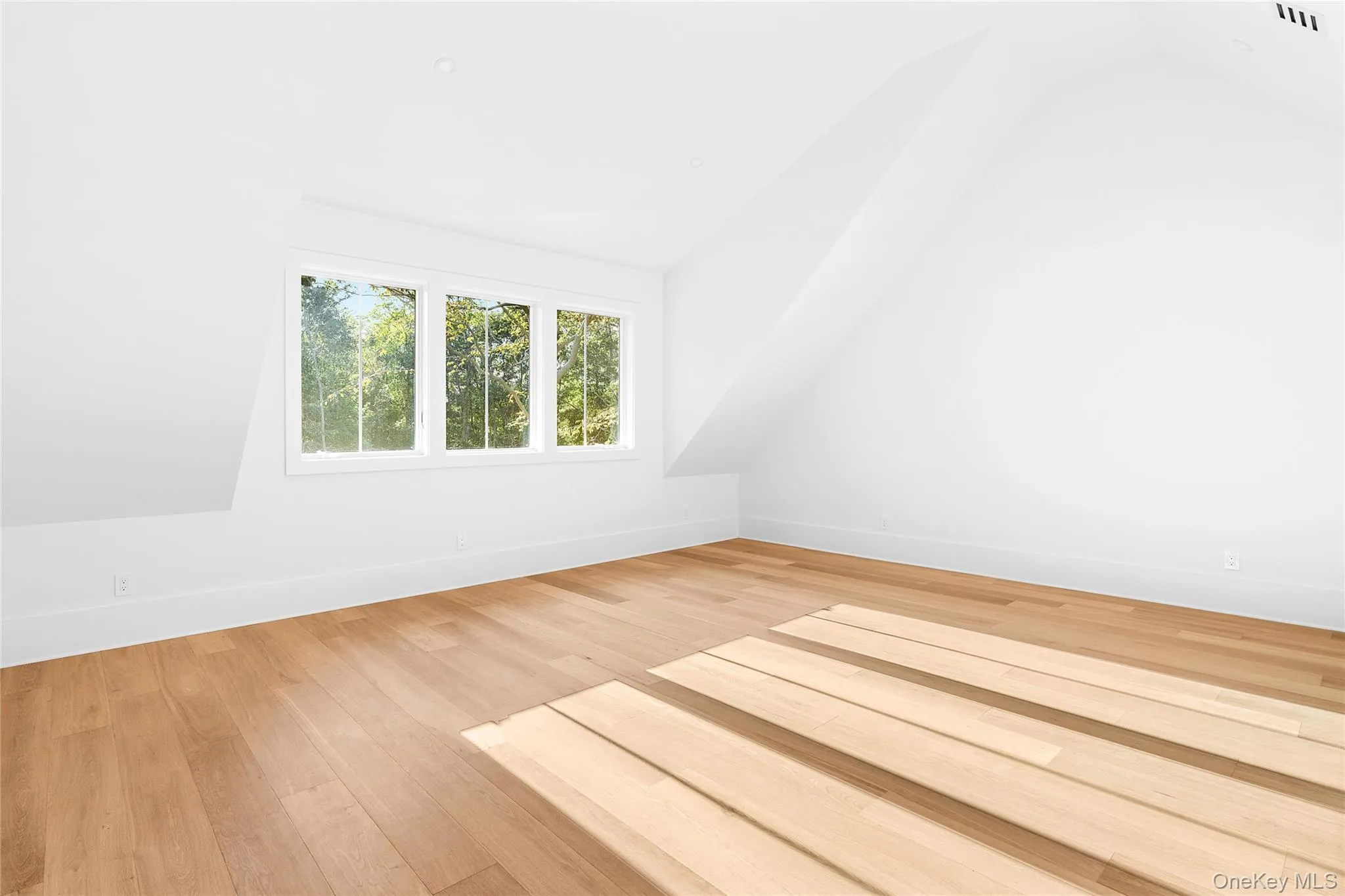 Bedroom with lofted ceiling and light wood-style floors Bedroom with lofted ceiling and light wood-style floors