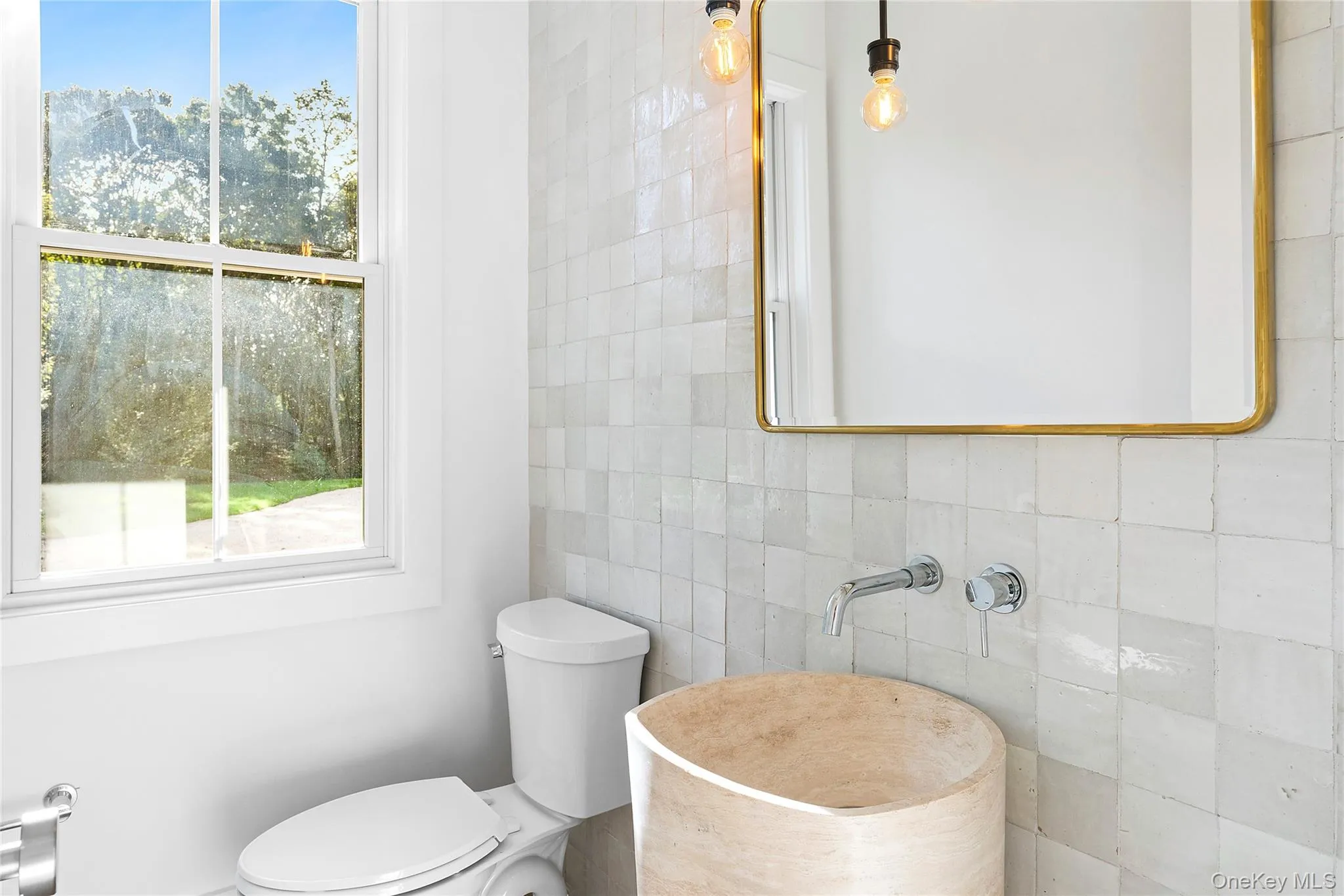 Bathroom featuring tile walls and toilet Bathroom featuring tile walls and toilet