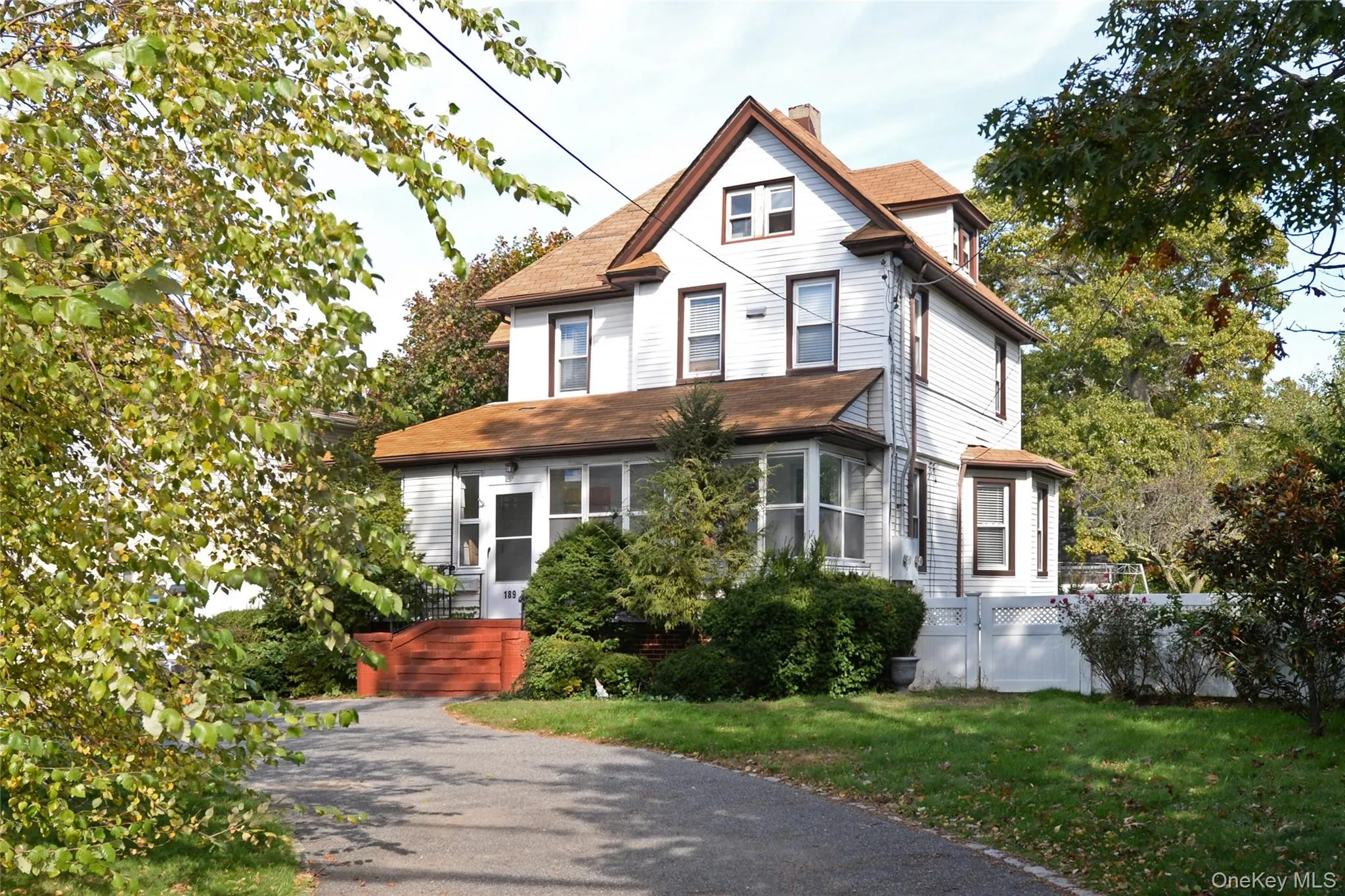 Victorian-style house with a chimney, a front lawn, and a shingled roof Victorian-style house with a chimney, a front lawn, and a shingled roof