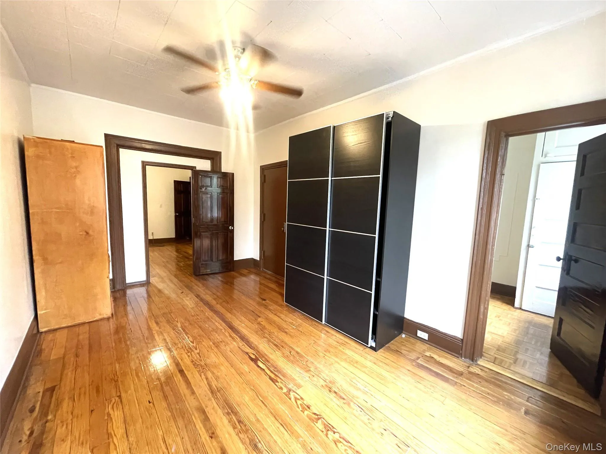 Unfurnished bedroom featuring light wood-style flooring, ceiling fan, and a closet Unfurnished bedroom featuring light wood-style flooring, ceiling fan, and a closet