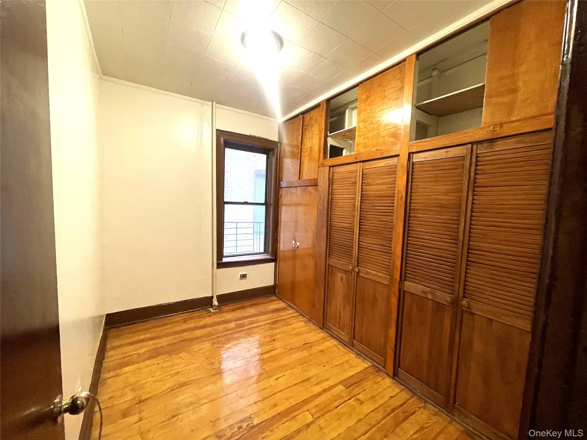 Unfurnished bedroom with light wood finished floors and a closet Unfurnished bedroom with light wood finished floors and a closet