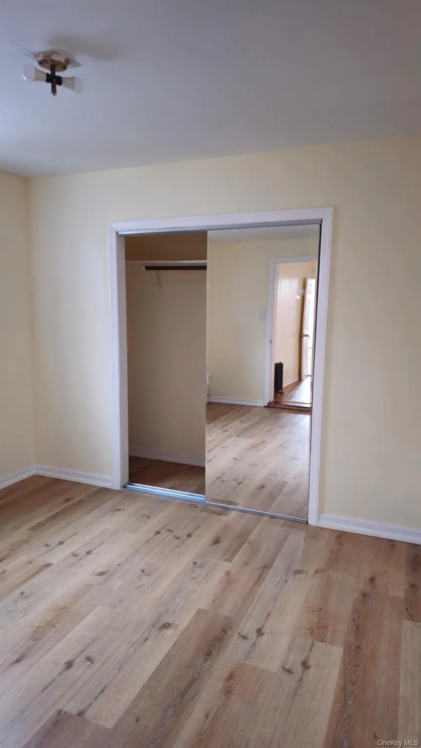 Unfurnished bedroom featuring light wood finished floors and a closet Unfurnished bedroom featuring light wood finished floors and a closet