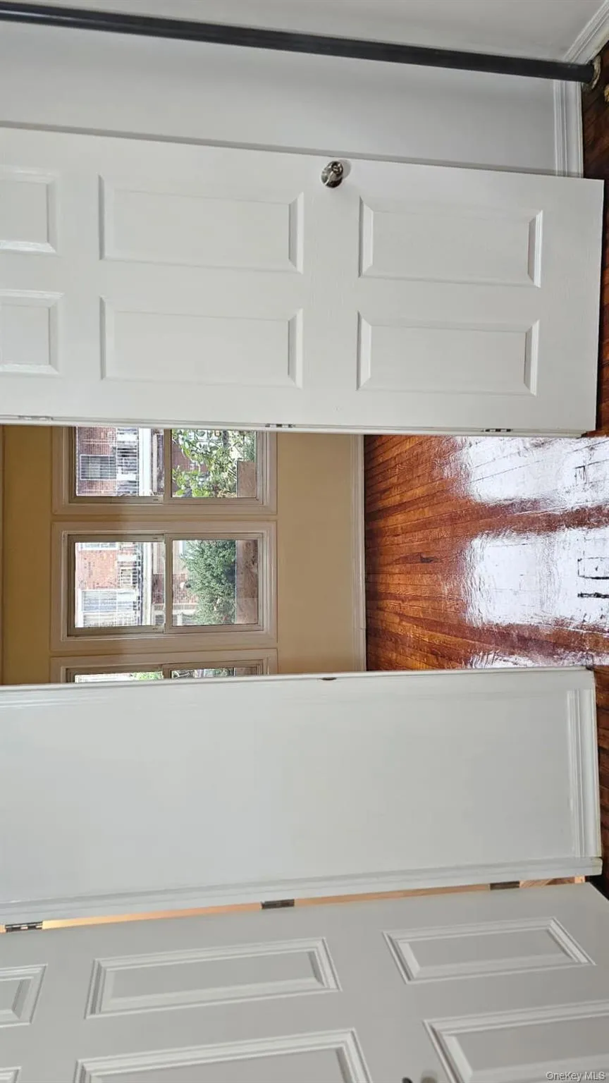 Hallway with baseboards and dark wood finished floors Hallway with baseboards and dark wood finished floors