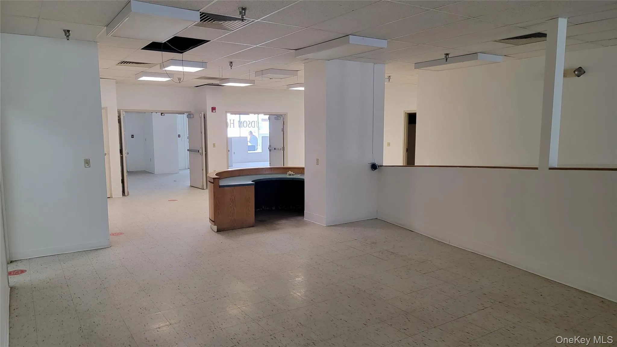Empty room featuring light flooring and a drop ceiling Empty room featuring light flooring and a drop ceiling