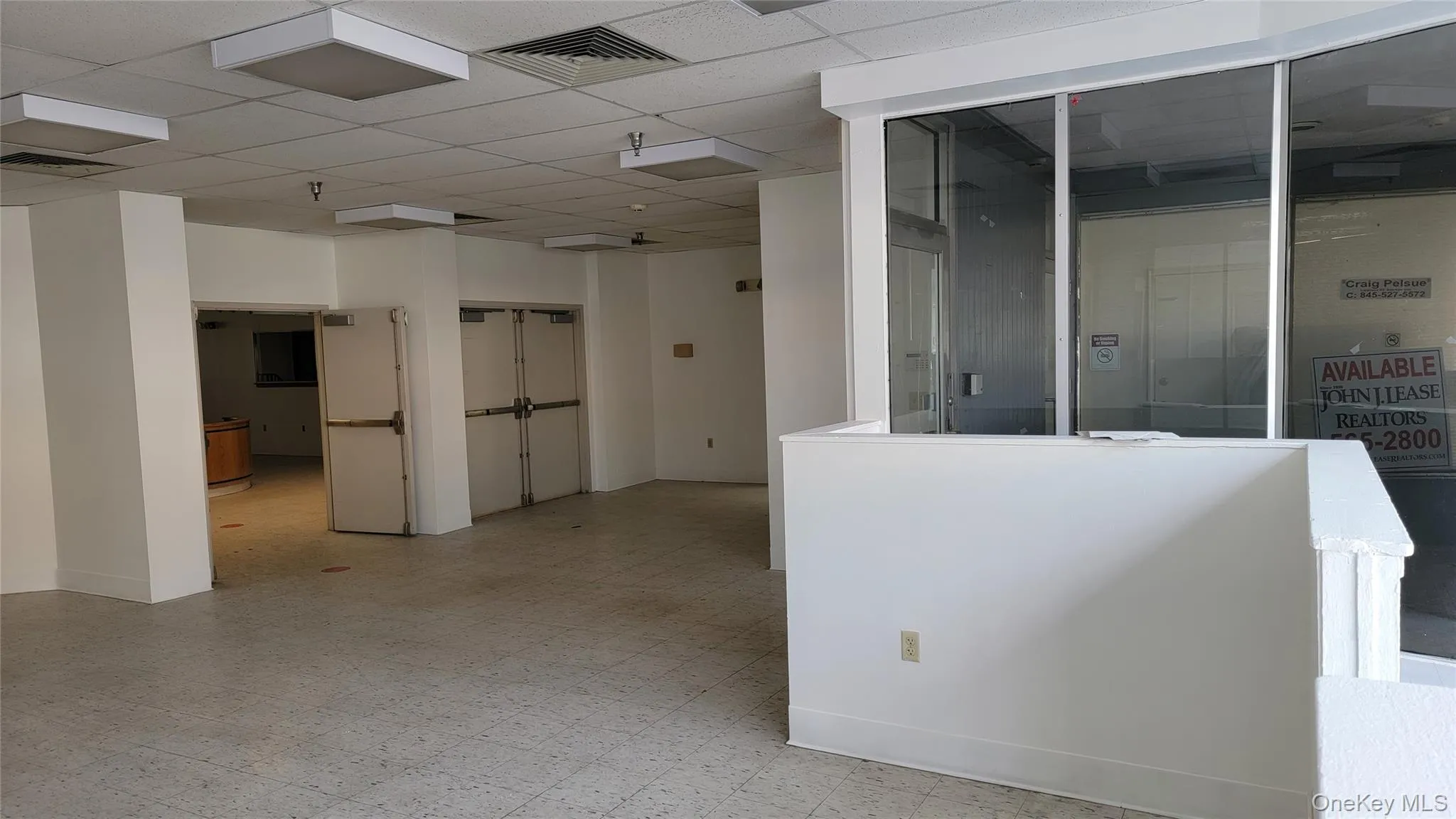 Spare room with tile patterned floors and a paneled ceiling Spare room with tile patterned floors and a paneled ceiling