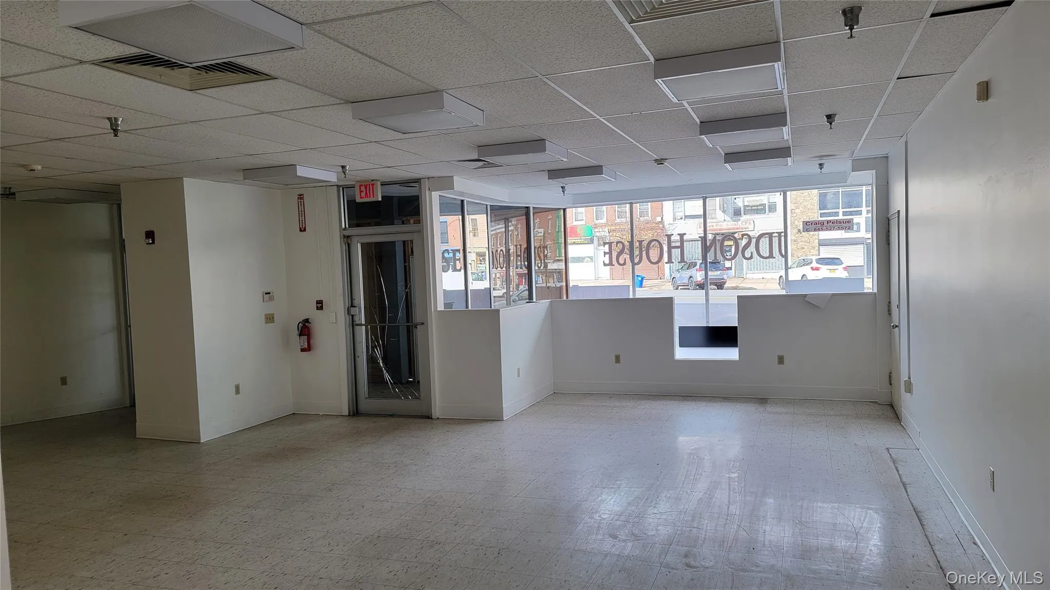 Unfurnished room with light flooring and a paneled ceiling Unfurnished room with light flooring and a paneled ceiling