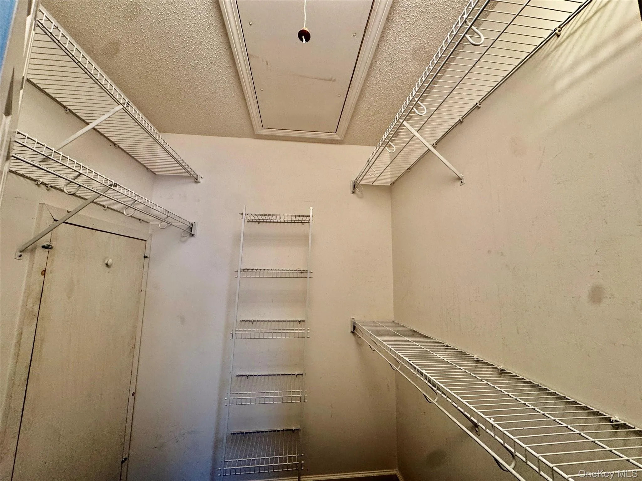 Primary Bedroom Walk in Closet with Pull Down Attic For Storage Primary Bedroom Walk in Closet with Pull Down Attic For Storage