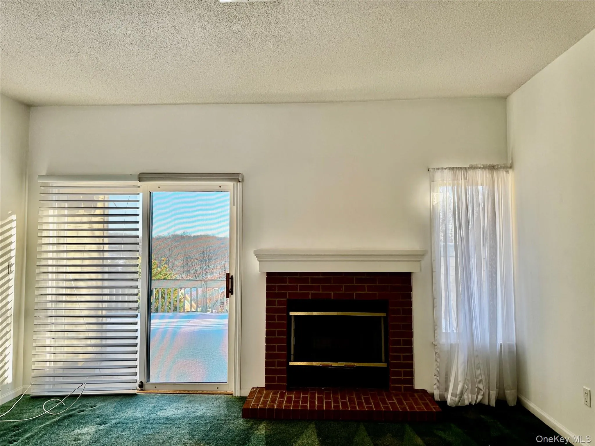 Living Room with Sliding Glass Doors to Deck overseeing the Complex Living Room with Sliding Glass Doors to Deck overseeing the Complex