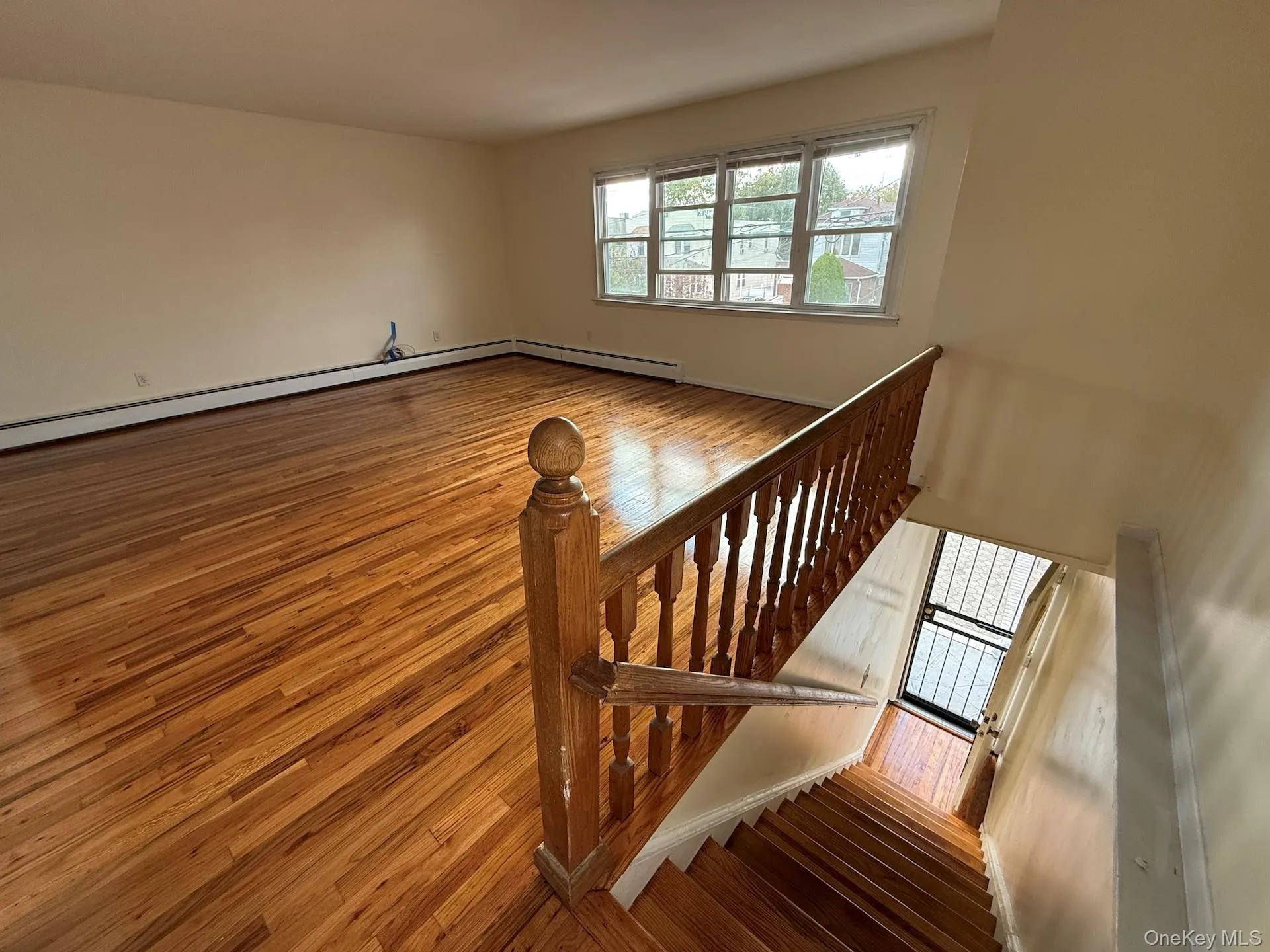 Staircase featuring wood finished floors and baseboard heating Staircase featuring wood finished floors and baseboard heating