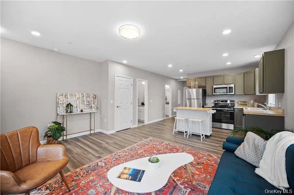 Living area with dark wood-style floors and recessed lighting Living area with dark wood-style floors and recessed lighting