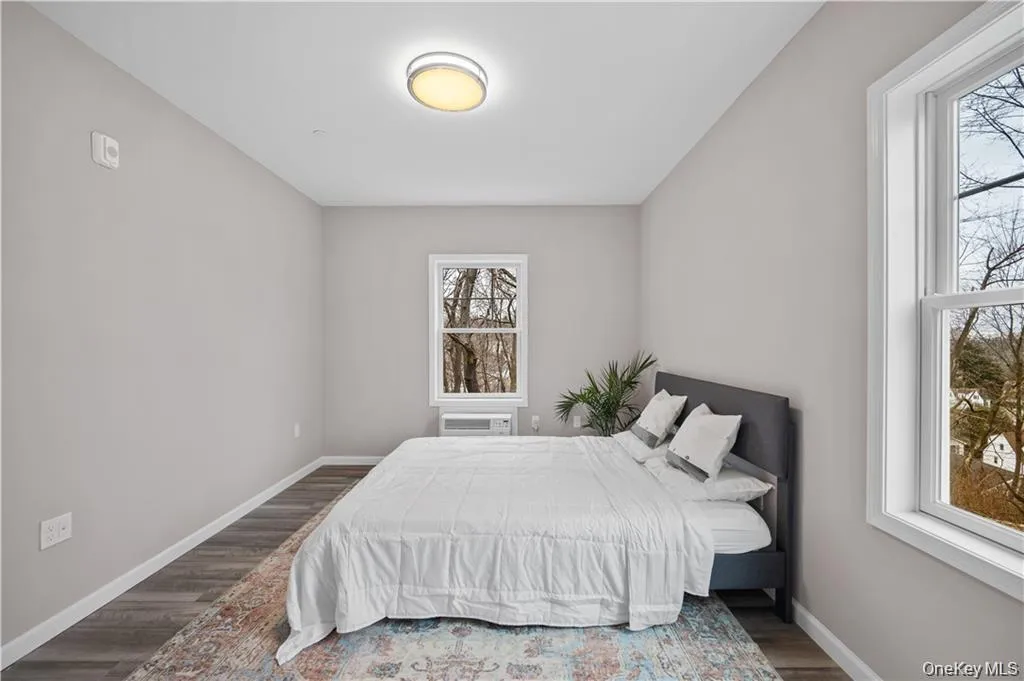 Bedroom with baseboards and wood finished floors Bedroom with baseboards and wood finished floors