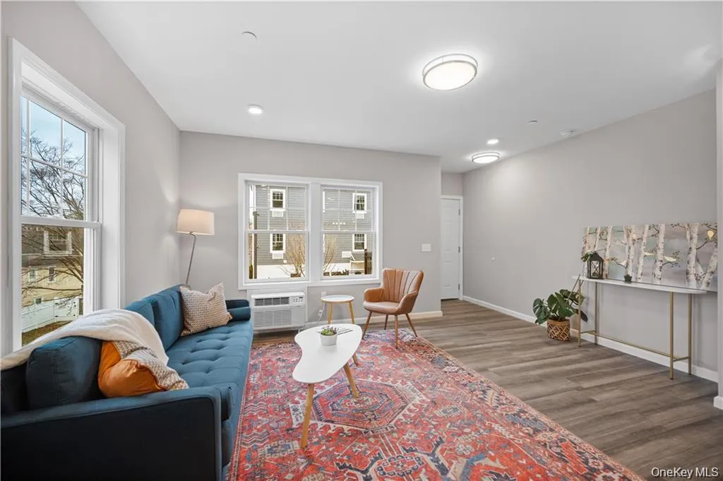 Living area with wood finished floors and recessed lighting Living area with wood finished floors and recessed lighting