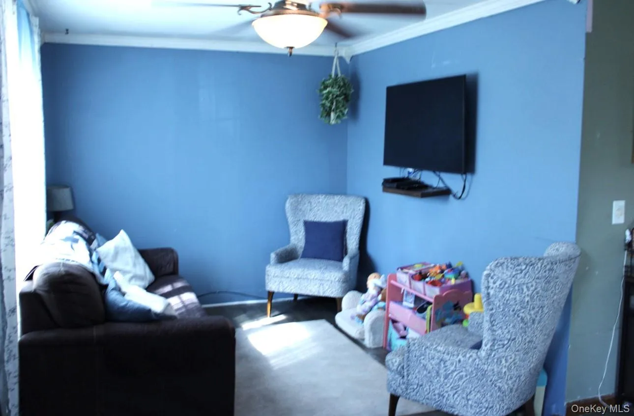 Sitting room featuring ornamental molding Sitting room featuring ornamental molding