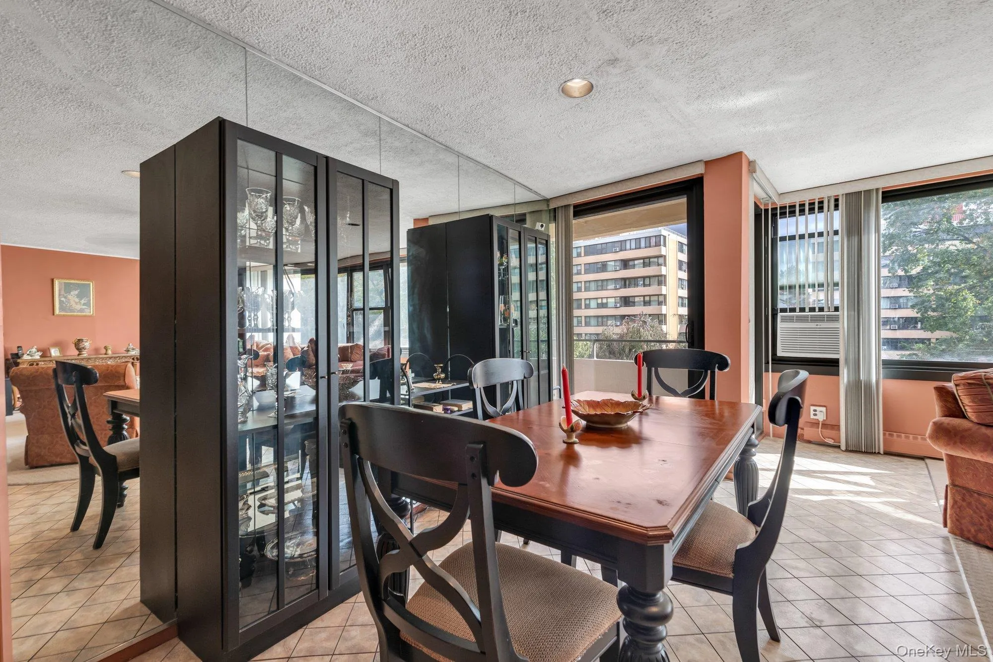 Dining space featuring light tile patterned floors and a textured ceiling Dining space featuring light tile patterned floors and a textured ceiling