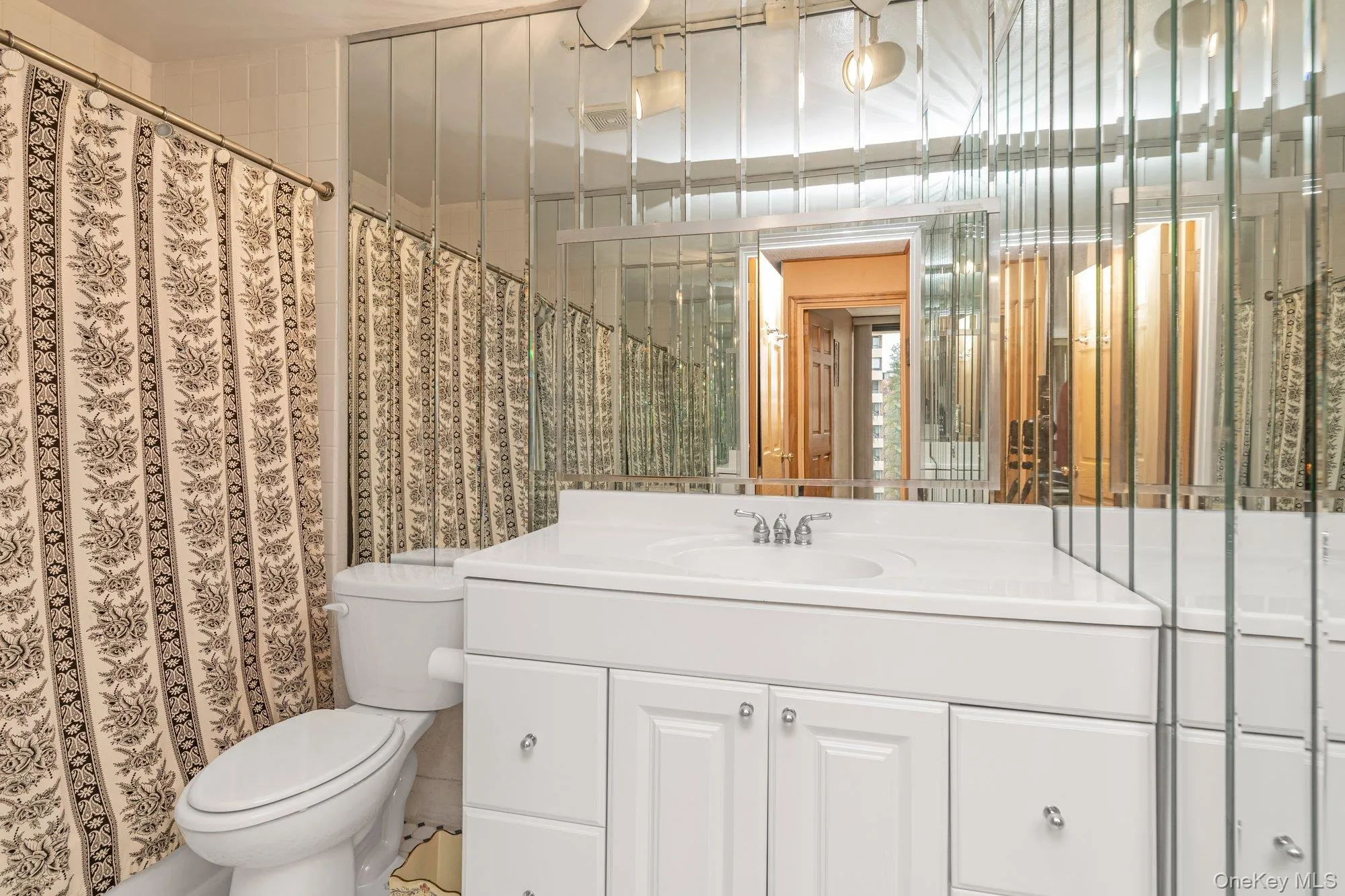Full bath featuring vanity and a shower with shower curtain Full bath featuring vanity and a shower with shower curtain