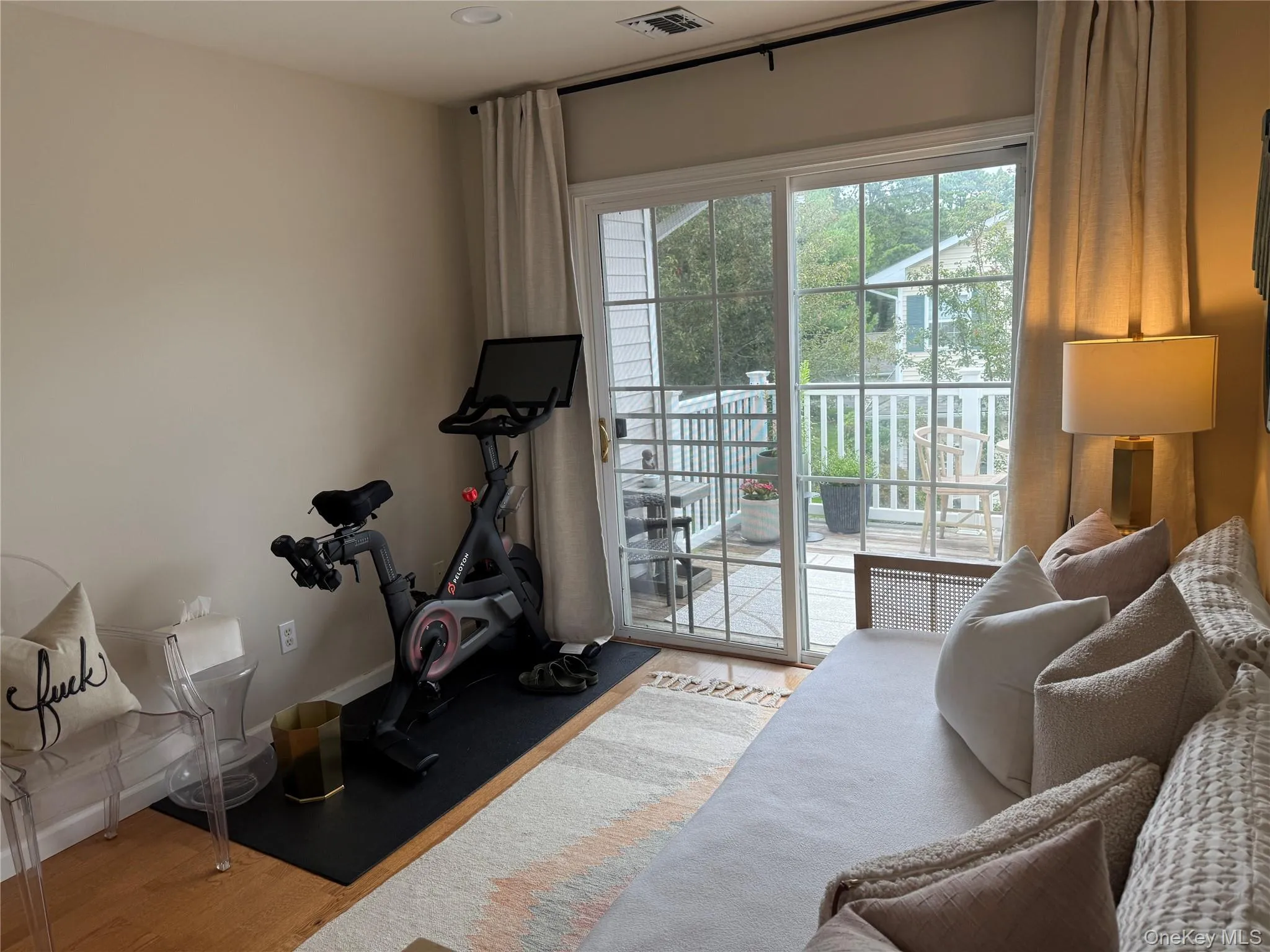 Workout area featuring wood finished floors and baseboards Workout area featuring wood finished floors and baseboards