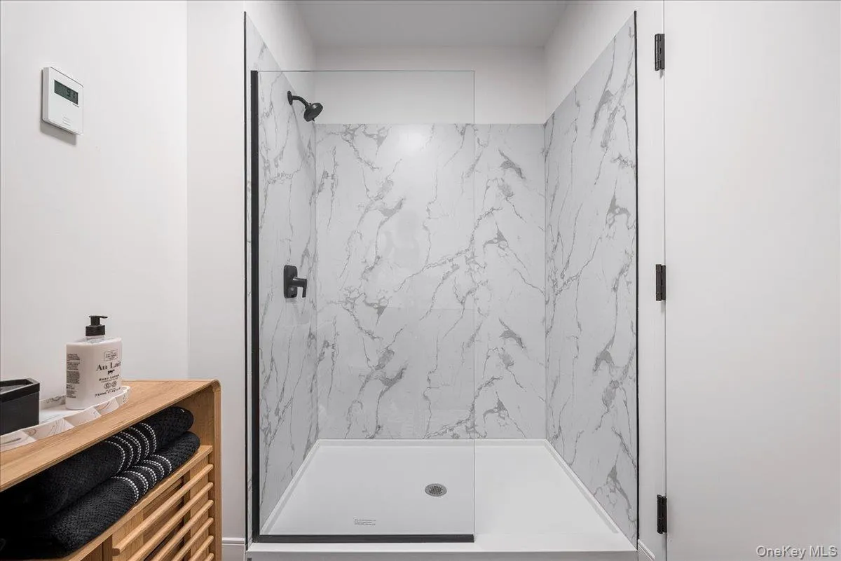 Full bath with a marble finish shower Full bath with a marble finish shower