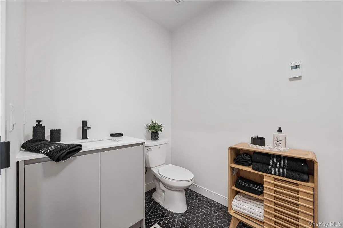 Bathroom featuring vanity and tile patterned floors Bathroom featuring vanity and tile patterned floors