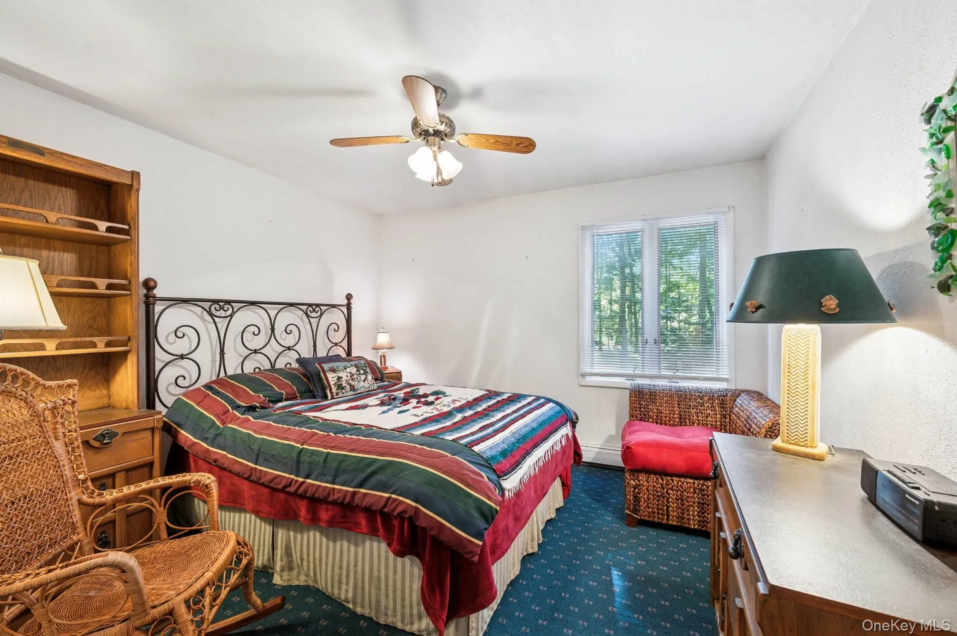 Bedroom with ceiling fan, dark colored carpet, and a desk Bedroom with ceiling fan, dark colored carpet, and a desk