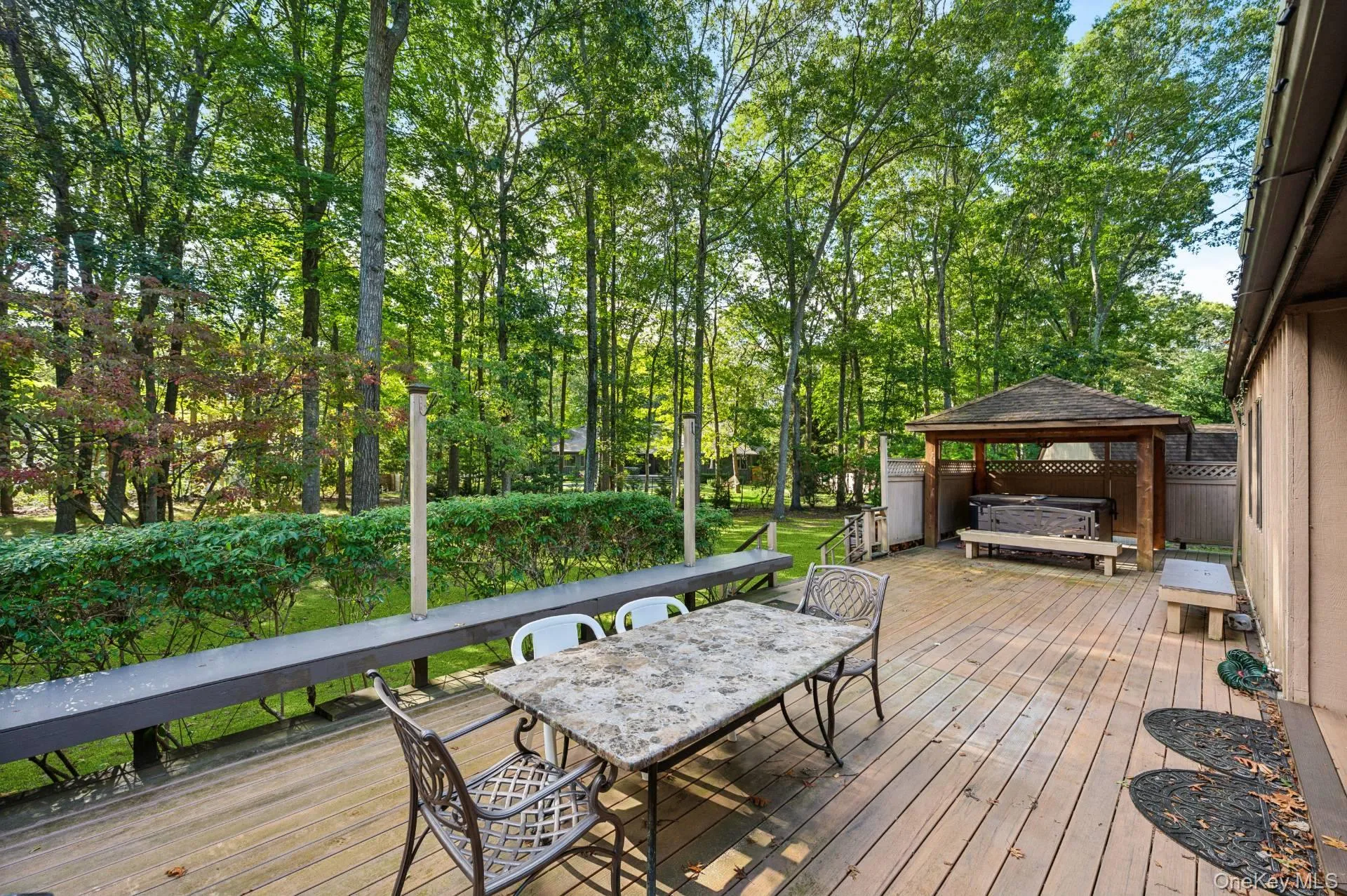 Deck featuring a gazebo and outdoor dining area Deck featuring a gazebo and outdoor dining area