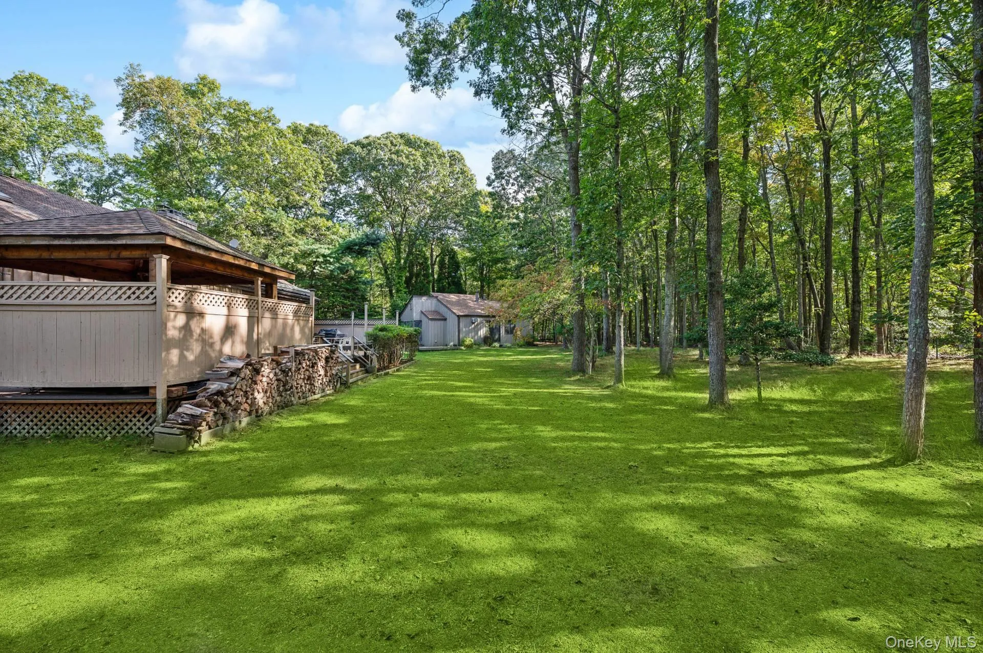View of grassy yard featuring a deck View of grassy yard featuring a deck