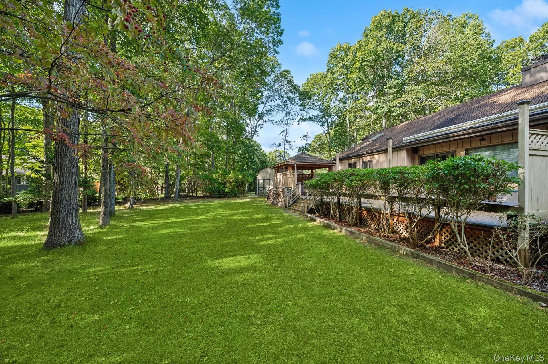View of grassy yard with a deck View of grassy yard with a deck