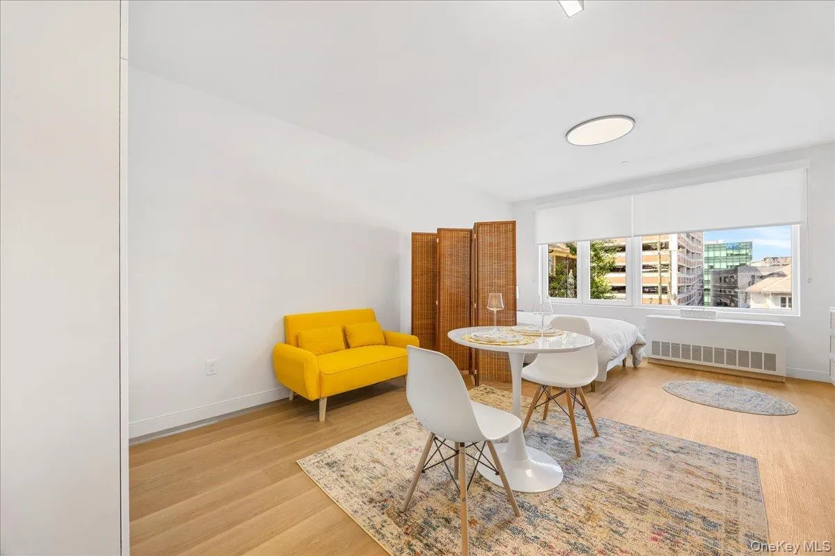 Dining space featuring radiator heating unit and light wood-style flooring Dining space featuring radiator heating unit and light wood-style flooring