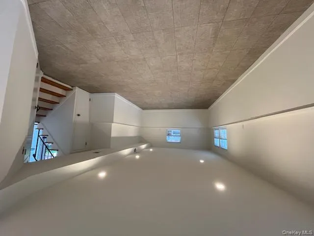 Basement featuring recessed lighting and stairs Basement featuring recessed lighting and stairs