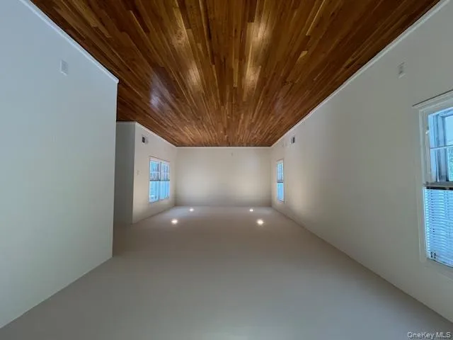 Living room featuring dark wood-type flooring and recessed lighting Living room featuring dark wood-type flooring and recessed lighting