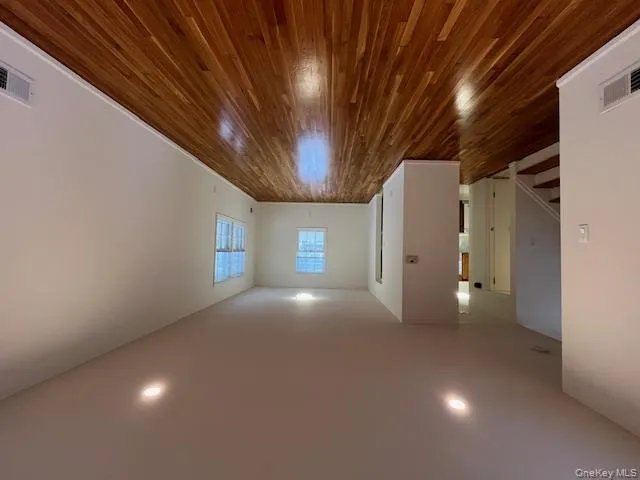 Living room featuring dark wood-style flooring, stairway, and recessed lighting Living room featuring dark wood-style flooring, stairway, and recessed lighting