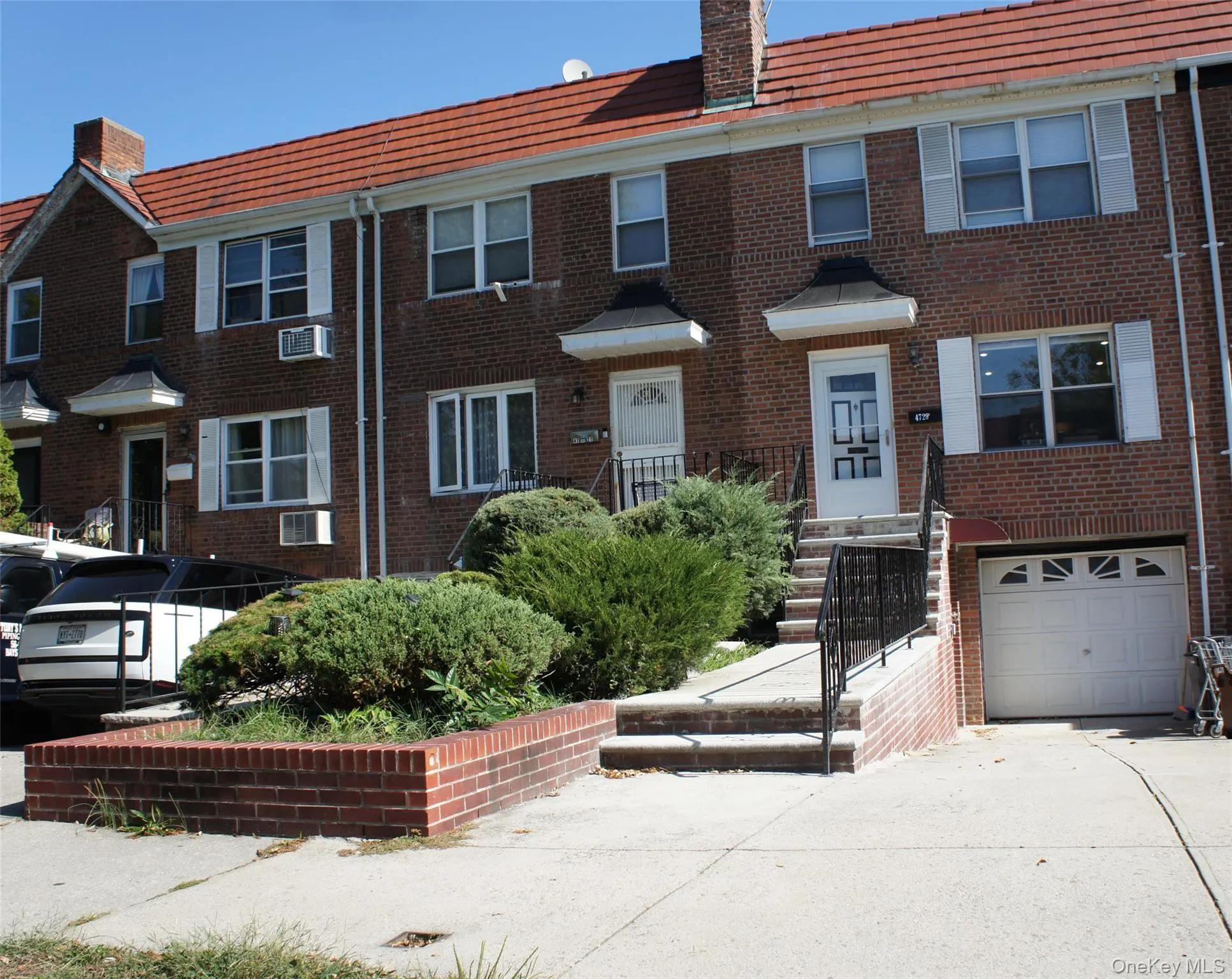 View of front of property featuring brick siding, a chimney, and concrete driveway View of front of property featuring brick siding, a chimney, and concrete driveway