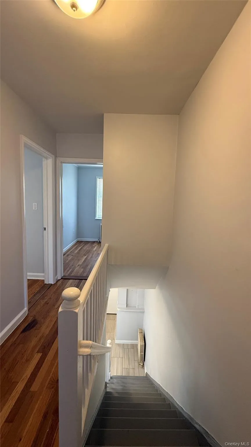 Staircase with wood finished floors and baseboards Staircase with wood finished floors and baseboards