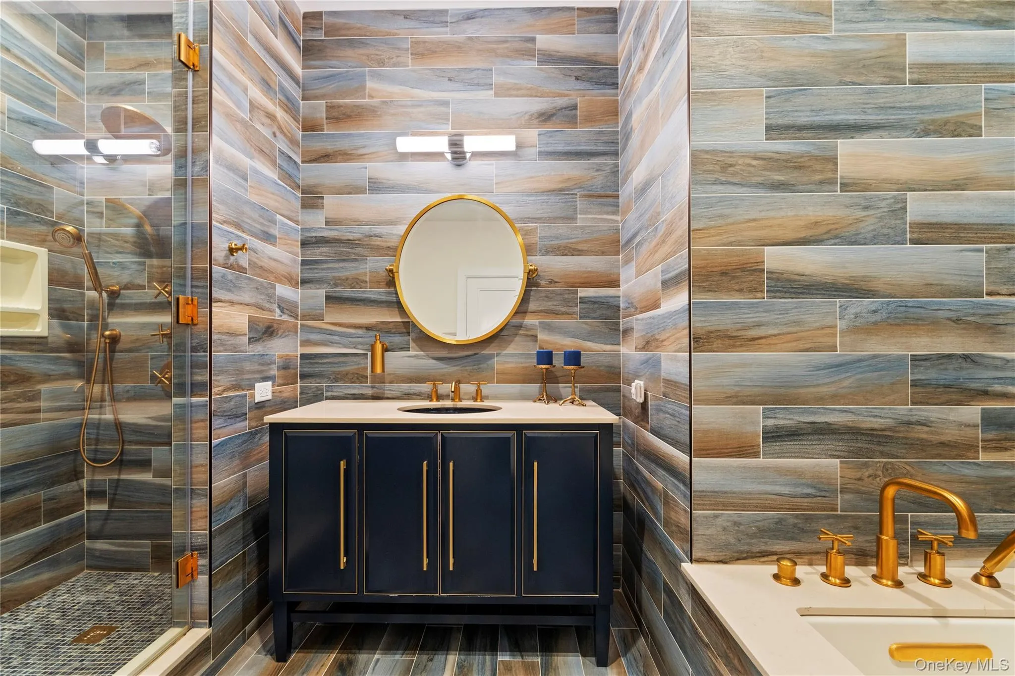 Bathroom featuring vanity, a walk in shower, and tile walls Bathroom featuring vanity, a walk in shower, and tile walls