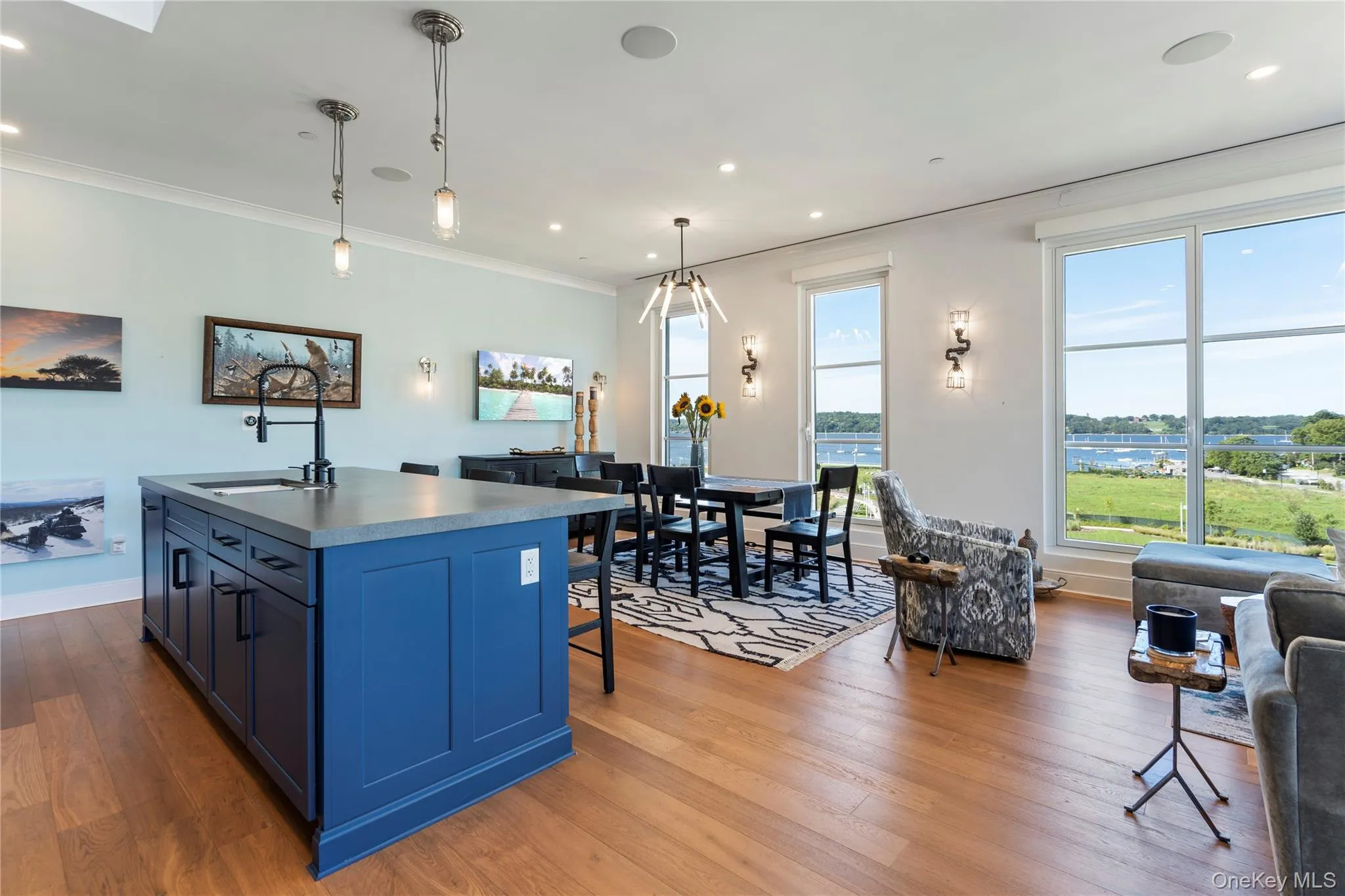 Kitchen featuring blue cabinetry, hanging light fixtures, and a kitchen island Kitchen featuring blue cabinetry, hanging light fixtures, and a kitchen island