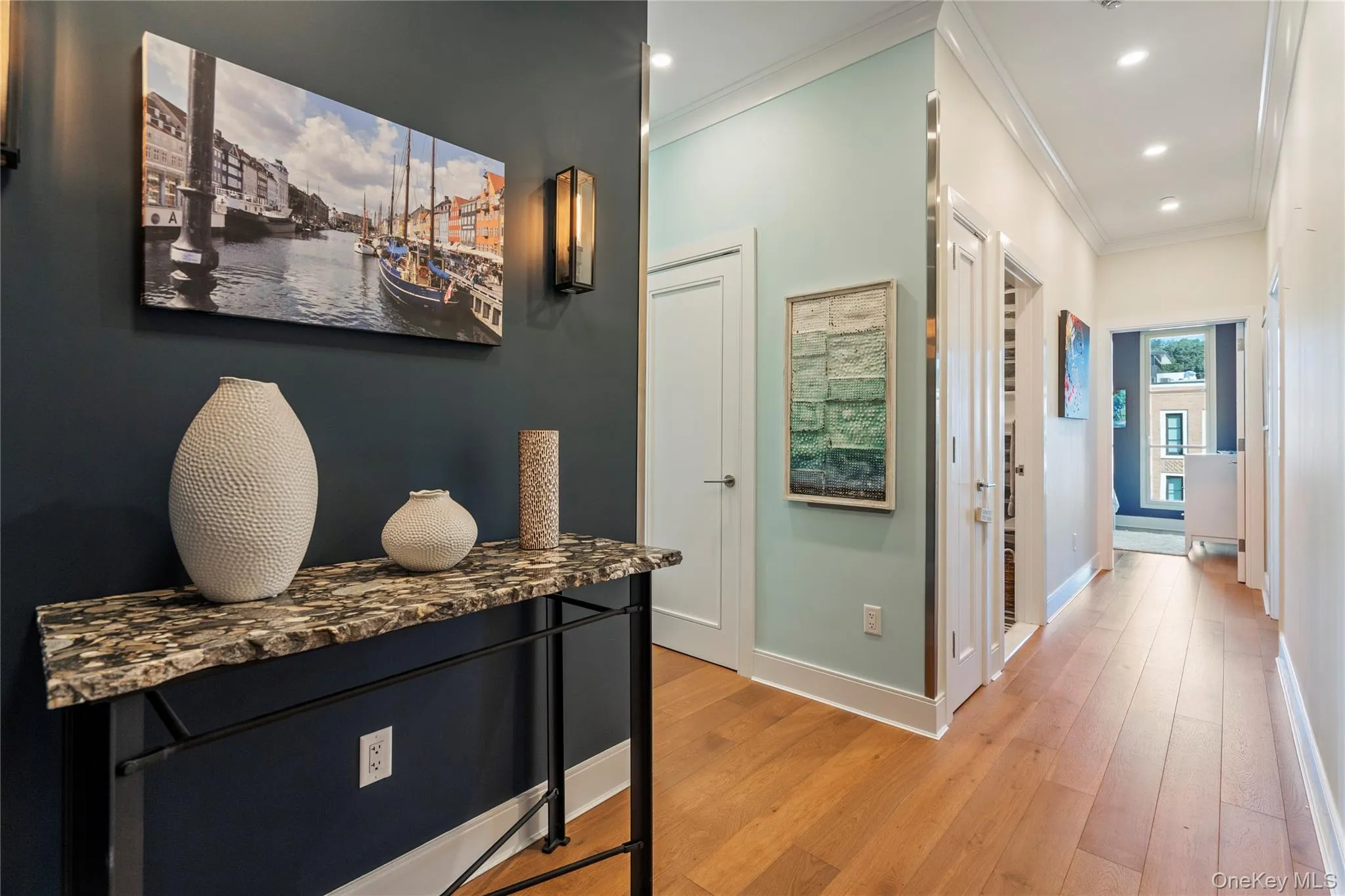 Corridor featuring crown molding, light wood finished floors, and recessed lighting Corridor featuring crown molding, light wood finished floors, and recessed lighting
