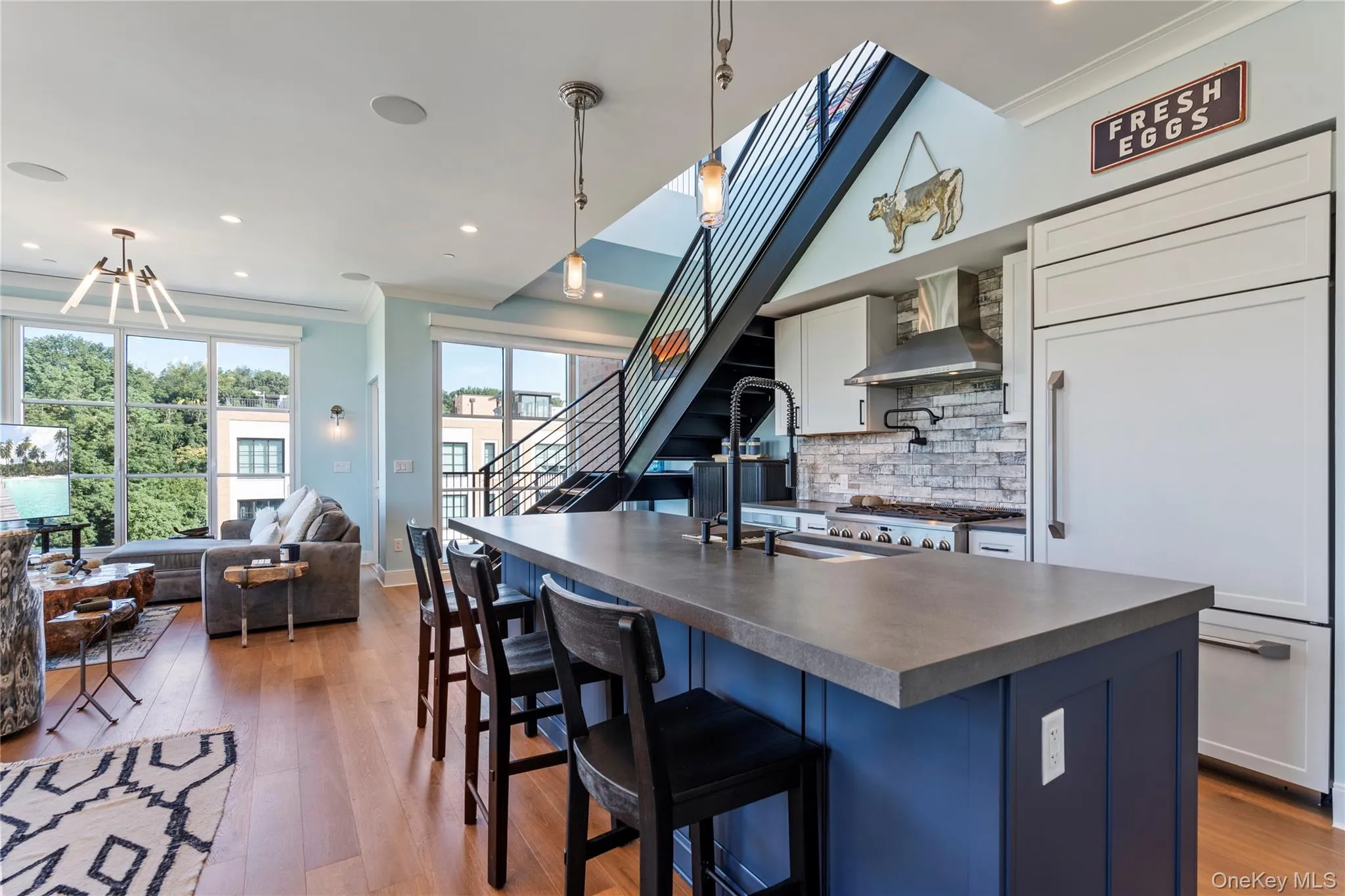 Kitchen with crown molding, a kitchen island, blue cabinetry, decorative backsplash Kitchen with crown molding, a kitchen island, blue cabinetry, decorative backsplash