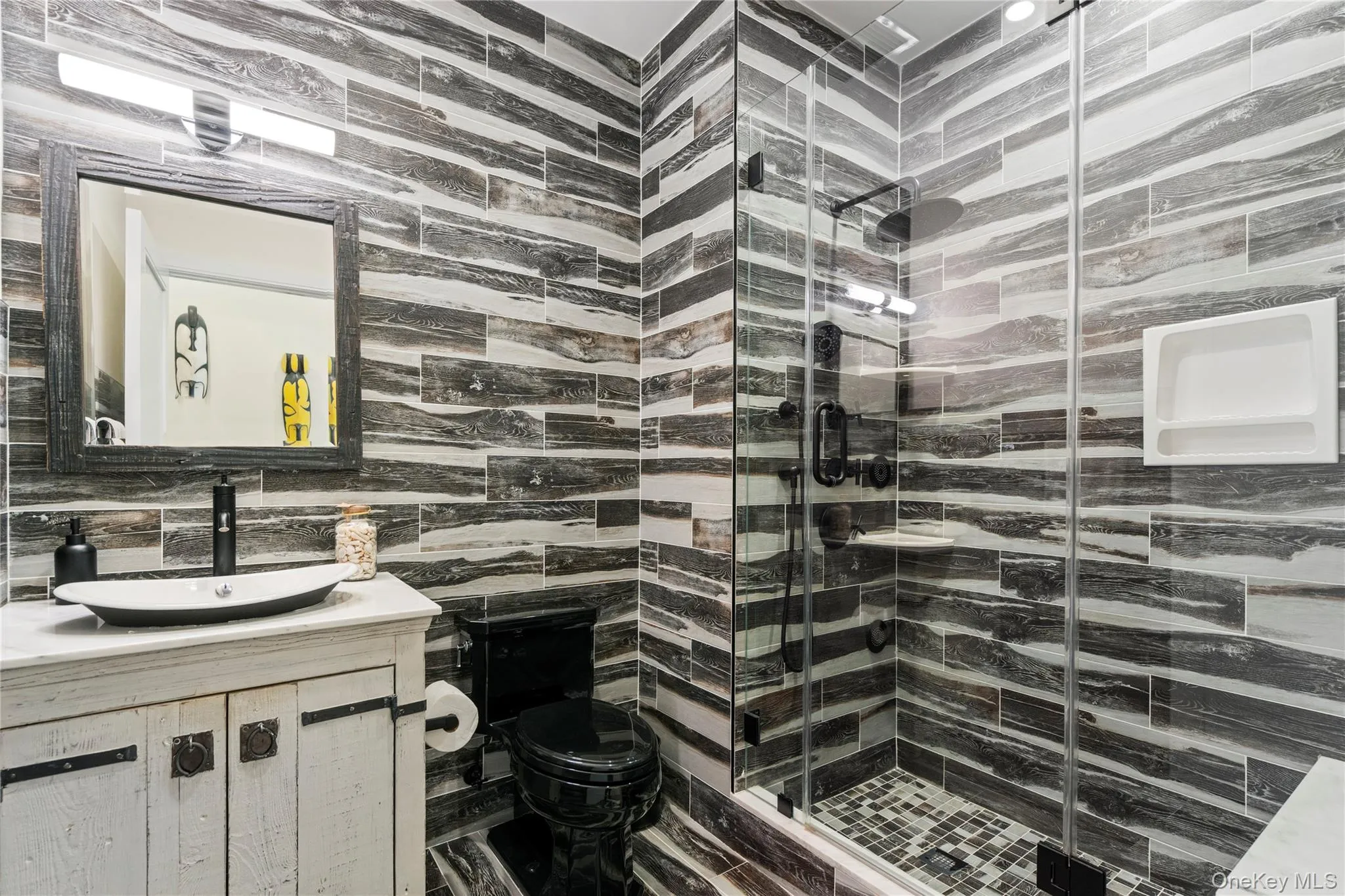 Full bath featuring vanity and a shower Full bath featuring vanity and a shower