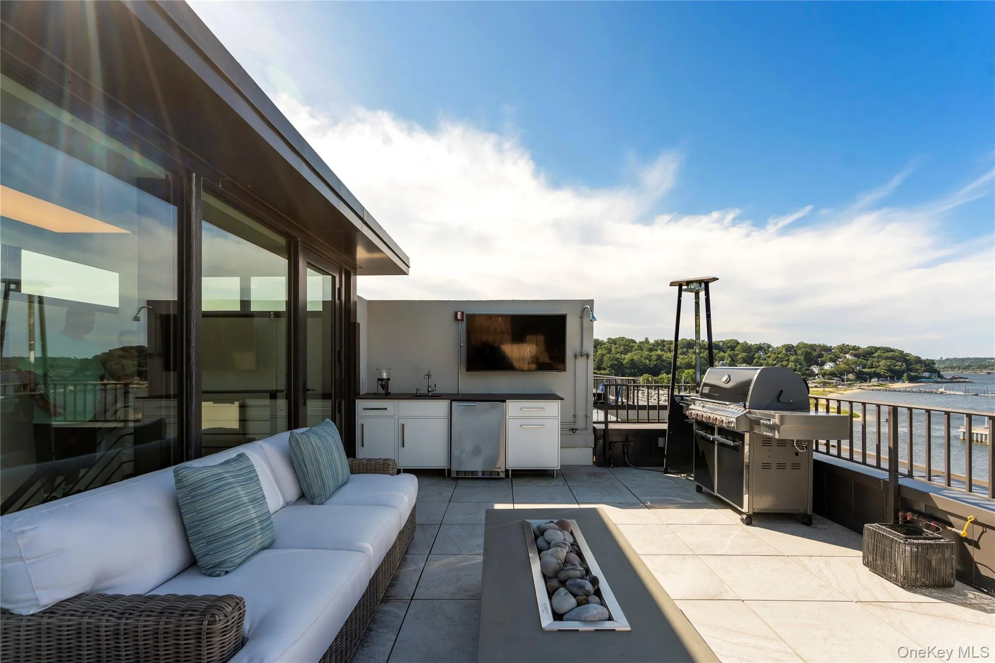View of rooftop terrace with an outdoor kitchen and a water view View of rooftop terrace with an outdoor kitchen and a water view