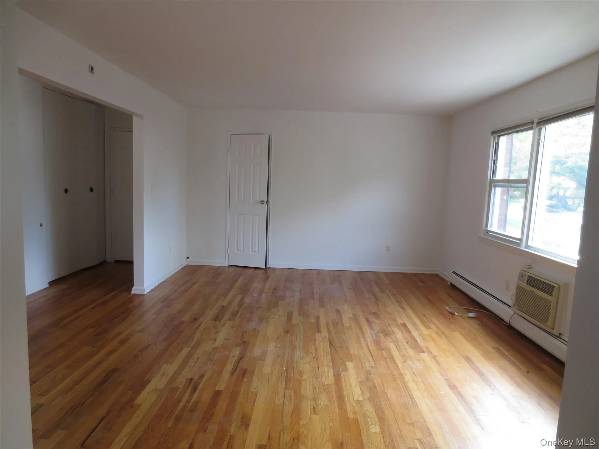 Living room featuring light wood flooring Living room featuring light wood flooring